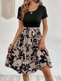 Women's khaki casual dress with floral print, A-line skirt, lace-up detail, and shoulder straps.