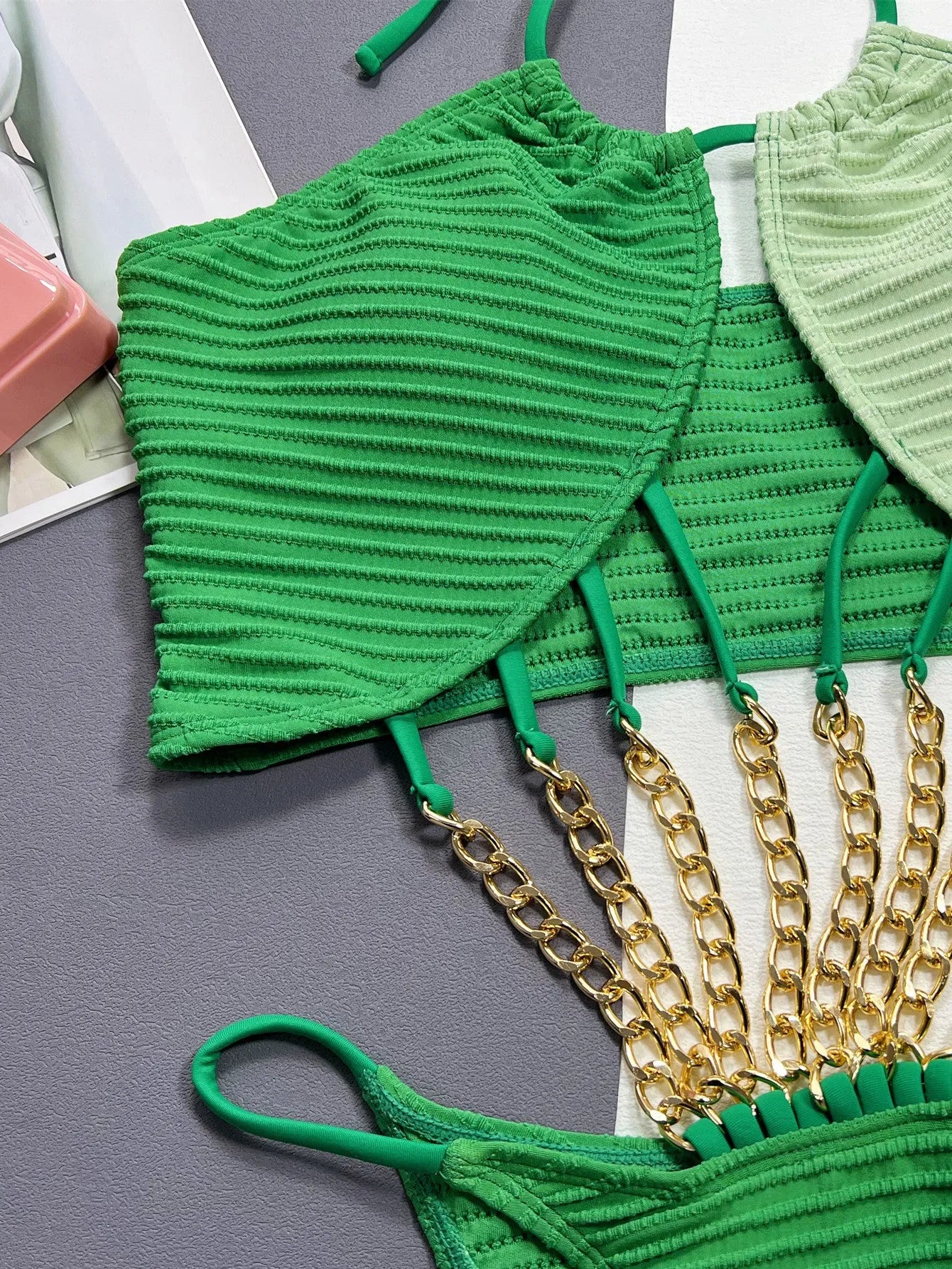 Green women's one-piece swimsuit with a hollow sexy cut on a mannequin.