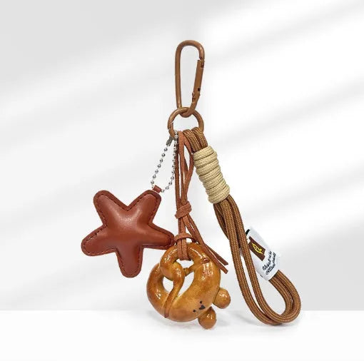 Handmade soda bread style resin handbag pendant with brown strap and baked varnish finish