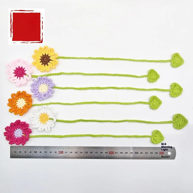 Hand-crocheted wool bookmark with flexible wire core and little daisy design in milk cotton yarn
