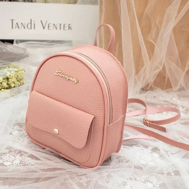 Women's small black PU leather backpack shoulder bag showing front zipper and dimensions