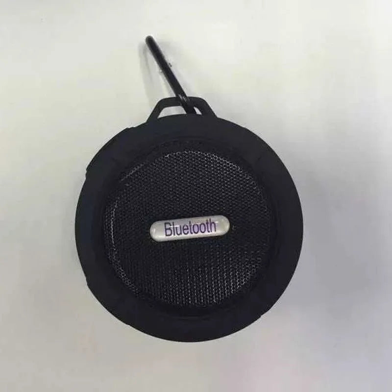 Portable waterproof Bluetooth speaker in multiple colours with a mountaineering buckle for bag attachment.