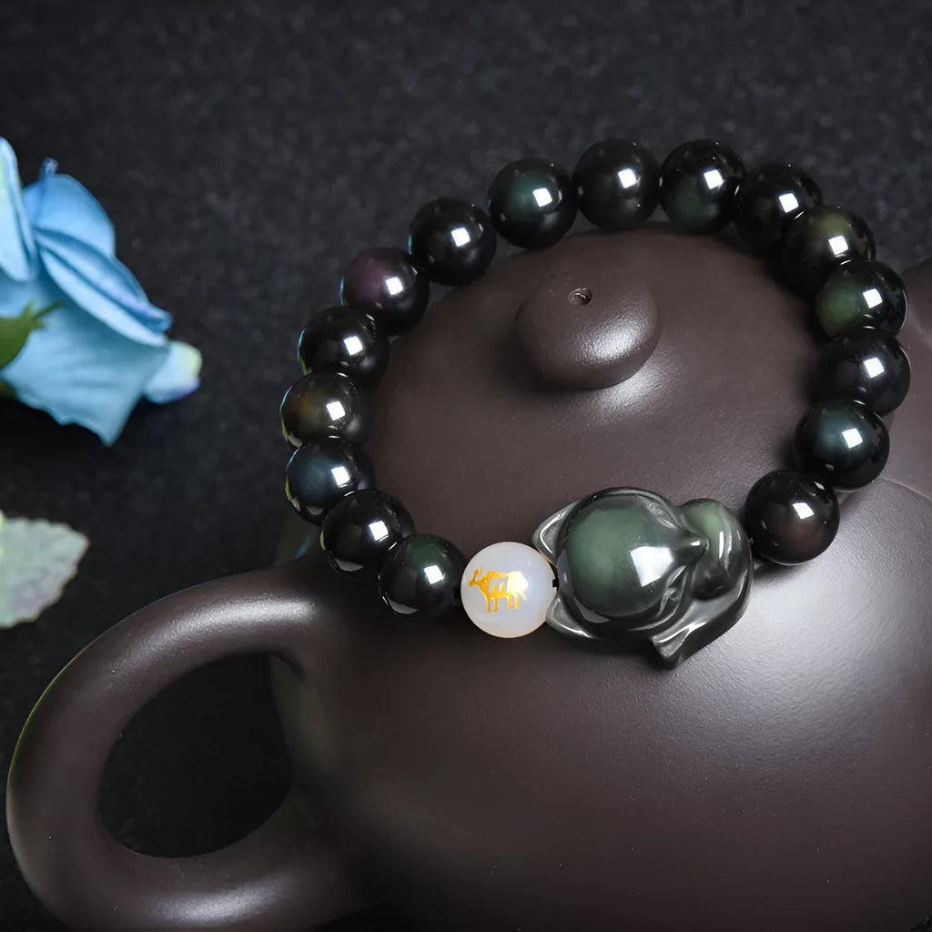 Natural obsidian stone bracelet with 10mm beads shown in gold, silver, and plain black style variations.
