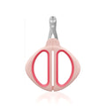 Close-up of a pink pet nail clipper showing the round positioning hole and stainless steel blade.