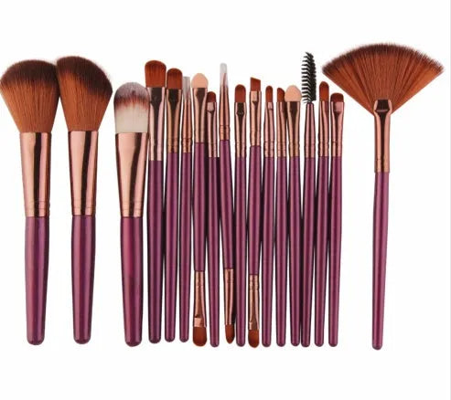 18-piece makeup brush set with fan brushes arranged on a table.