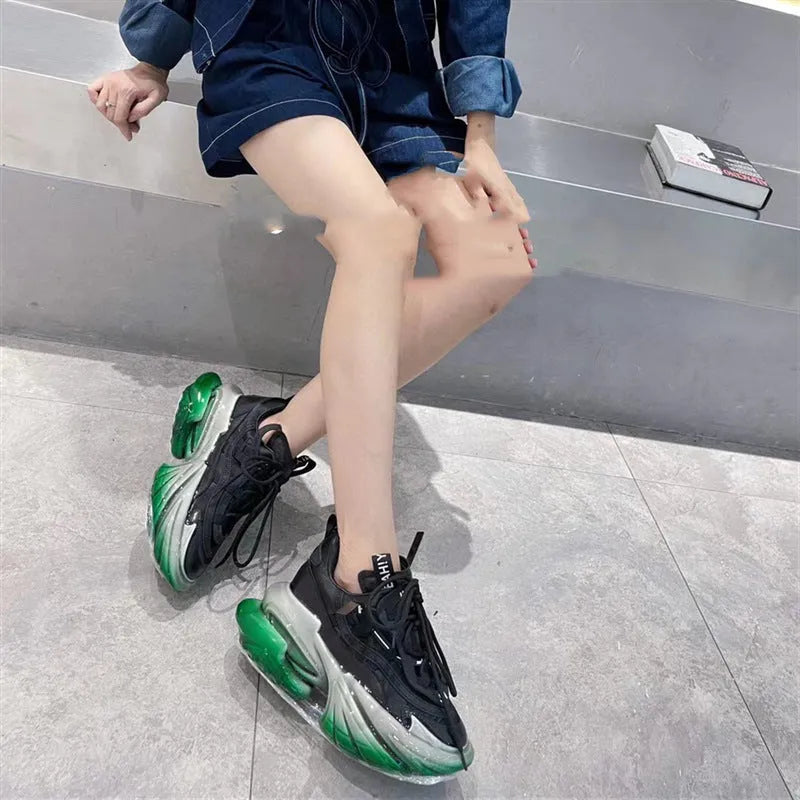Women's leather sports shoes with a thick jelly sole and white cross-tie fastening on a round toe.