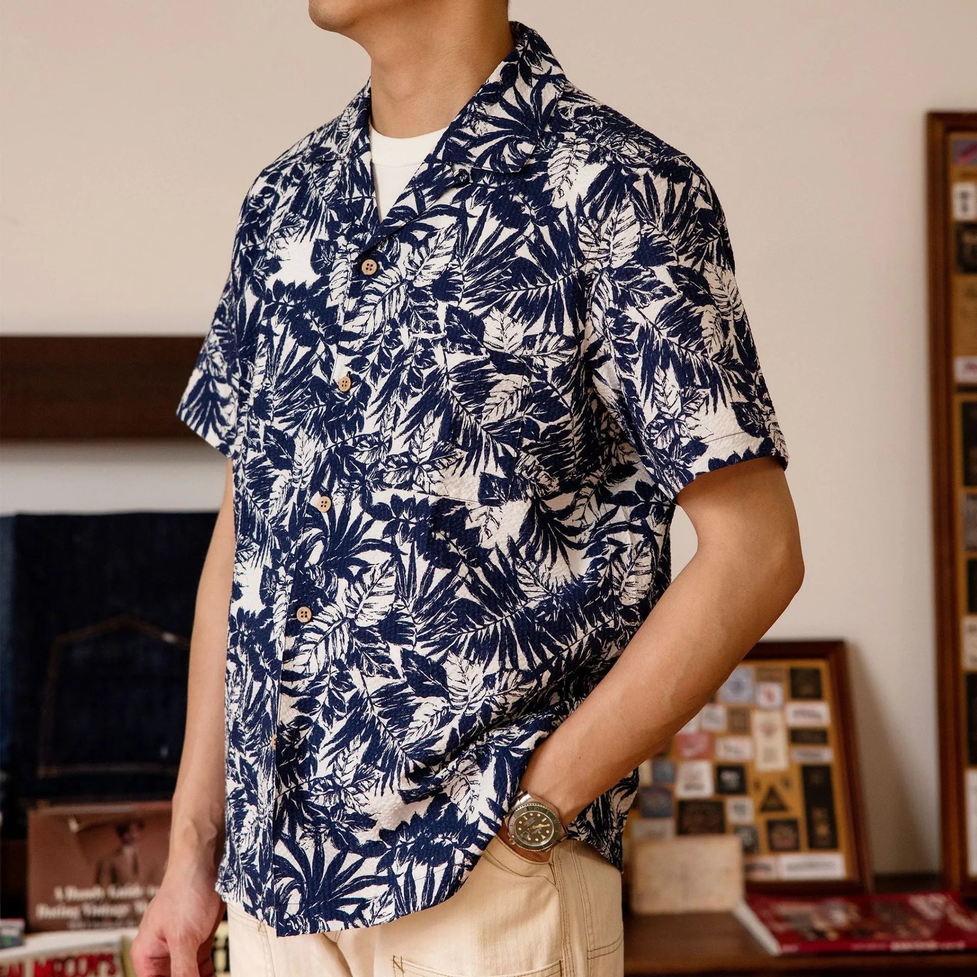 Man wearing a green vintage floral print seersucker shirt with a Cuban collar.