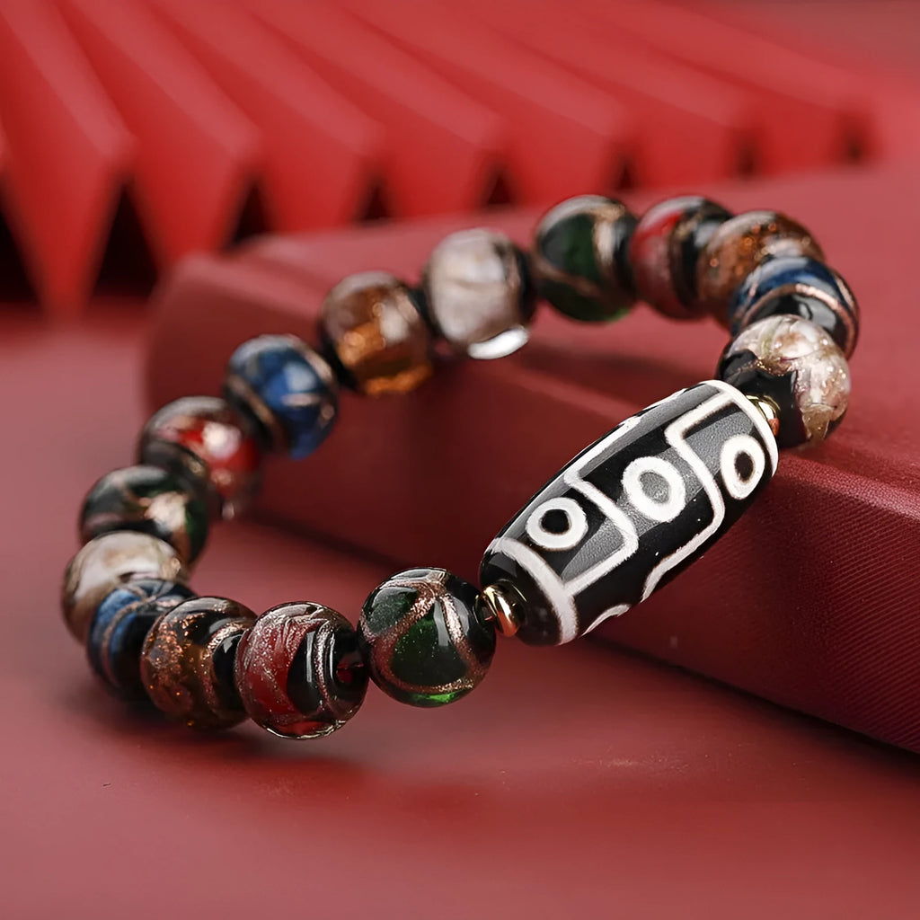 Close-up of a coloured glaze bracelet with traditional Chinese snake design and multi-coloured beads.
