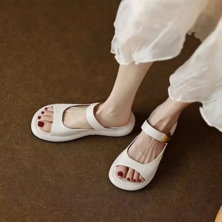 Women's apricot peep toe flat platform sandals made of soft leather with a rubber sole.