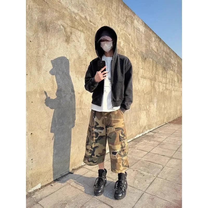 Men's camouflage cropped jeans with patch detailing and ripped accents in straight leg style