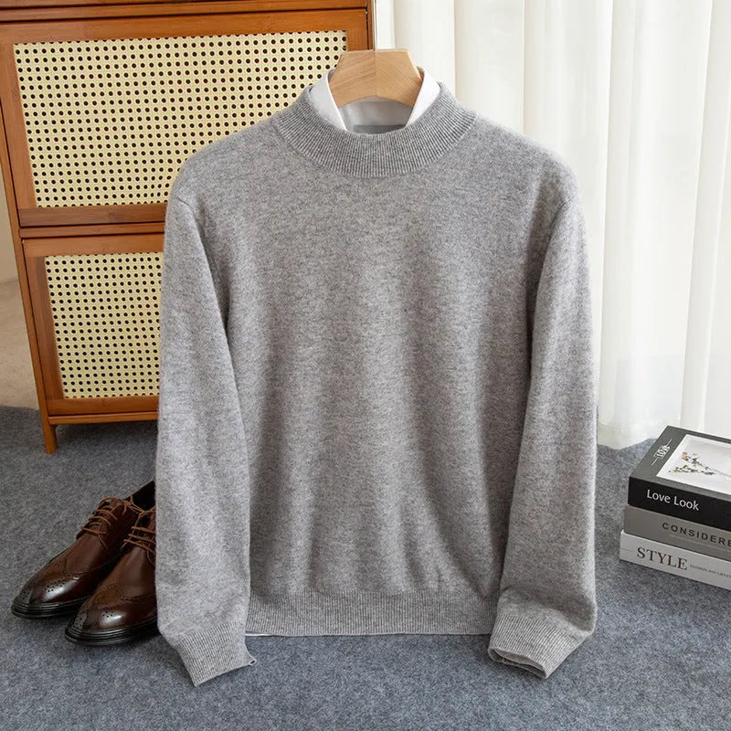 Man wearing a half-collar loose wool sweater in a textured rough yarn knit.
