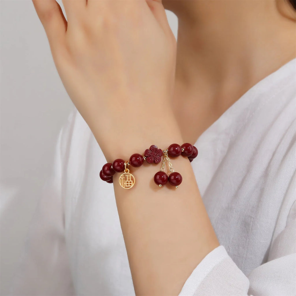 Traditional cinnabar women's bracelet with fu character centrepiece in purple and gold sand colours
