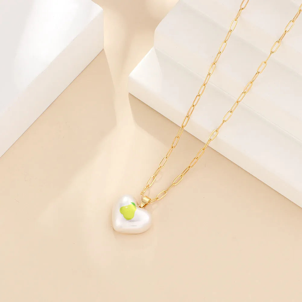 Geometric heart fruit pendant necklace with adjustable chain showing strawberry, pineapple, apple designs