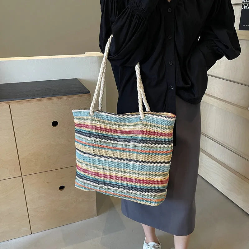 Blue woven nylon shoulder bag with straw-inspired basket construction and polyester lining