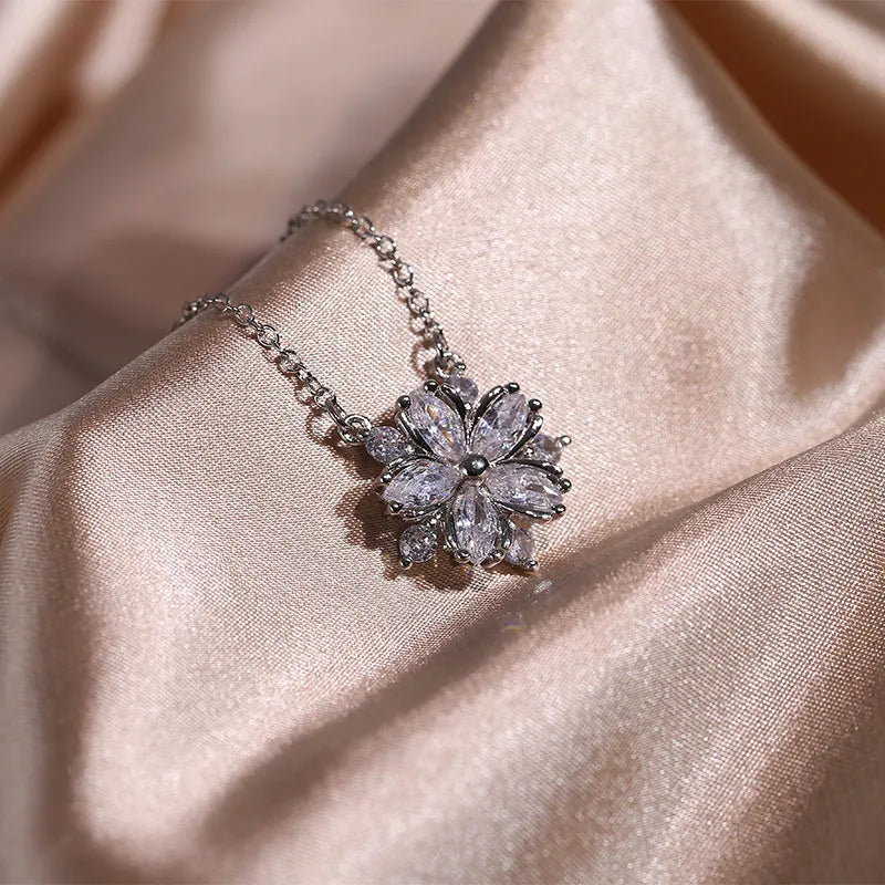 Double layer flower cubic zirconia ring necklace and stud earrings set in white copper on display