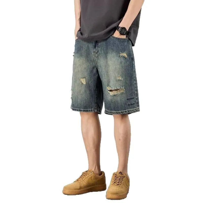 Retro blue denim men's shorts with loose hole details and straight leg.