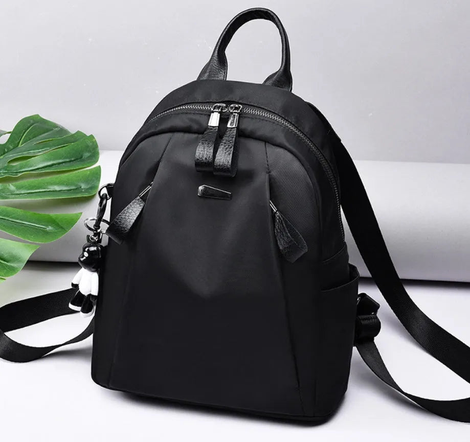 Medium wild fashion rucksack in Oxford cloth with vertical square shape, double straps, and zipper closure available in black, gray and wine red