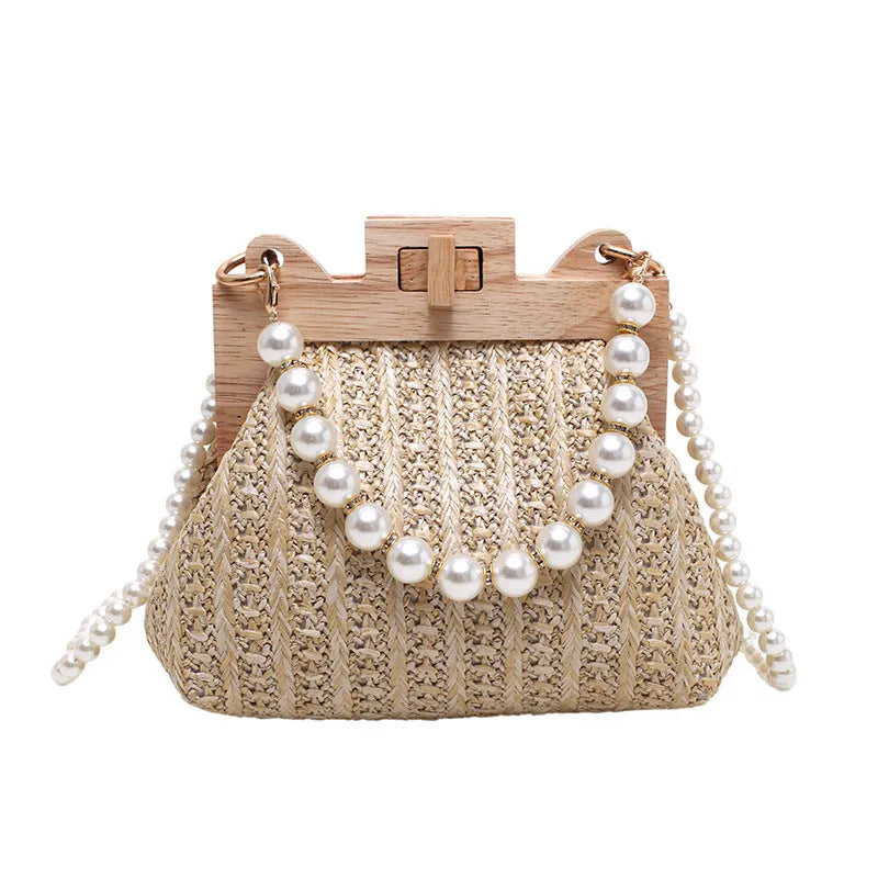 Beige woven straw women's shoulder bag with pearl chain detail, showing interior zipper pockets.
