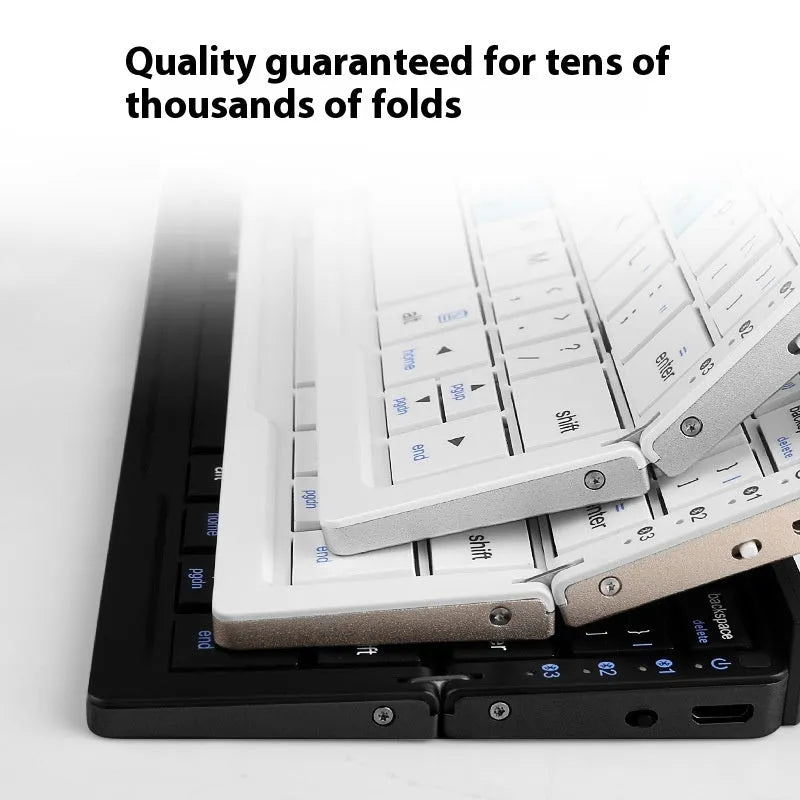 Folding Bluetooth keyboard in black gray for tablets and phones on a plain background
