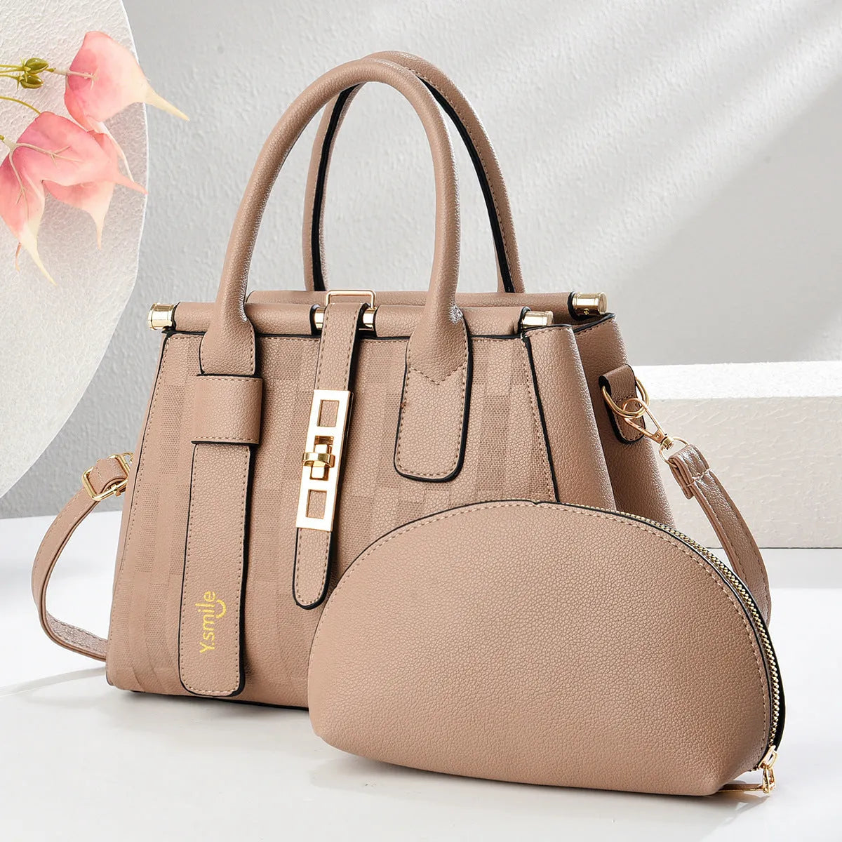 Round PU leather crossbody handbag in light khaki colour showing front view and adjustable shoulder strap.