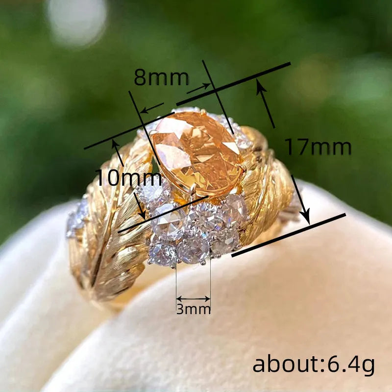 Gold-colour copper feather ring with embossed design and yellow zircon inlay on geometric shape
