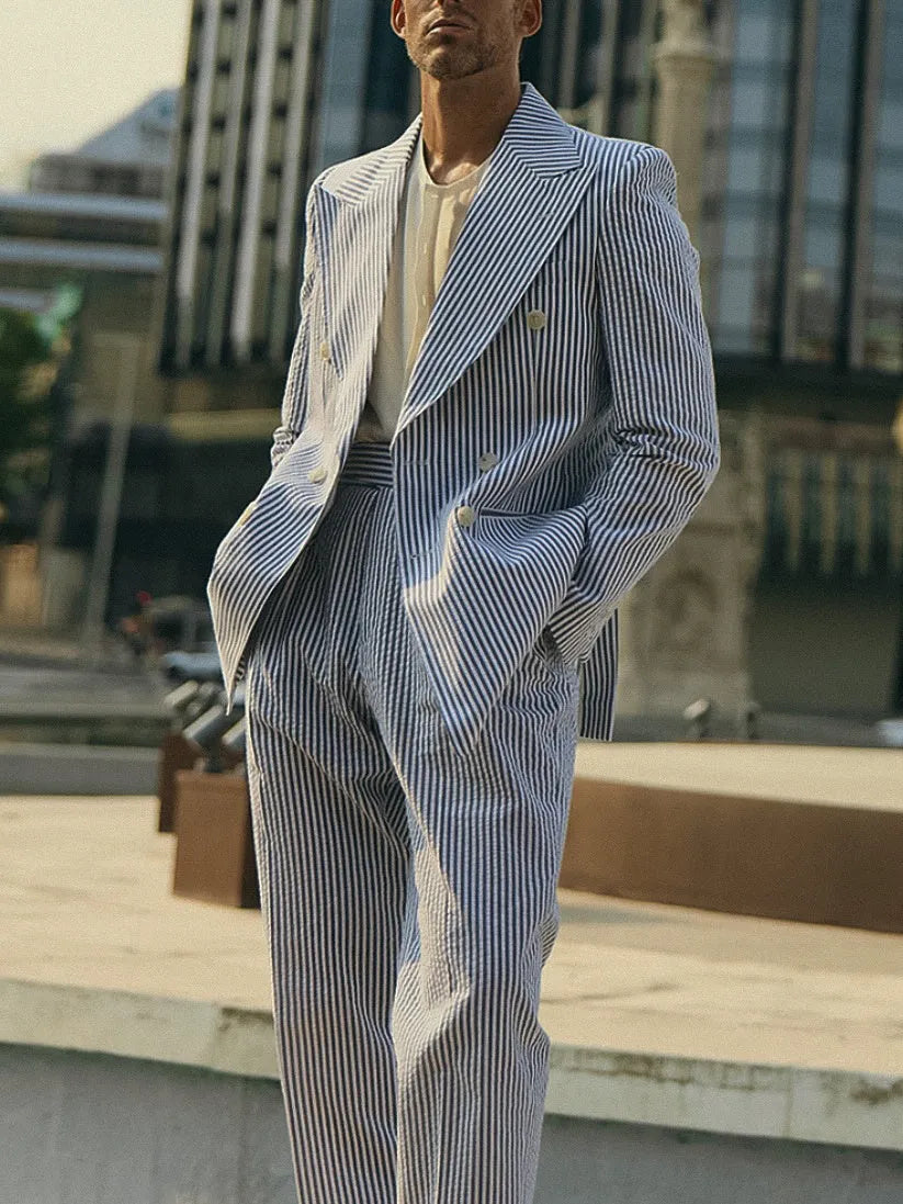 Blue and white striped polyester two-piece suit set with blazer and trousers on a hanger.
