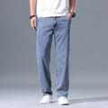 Man wearing light blue loose straight-leg Lyocell jeans with a zipper fly.