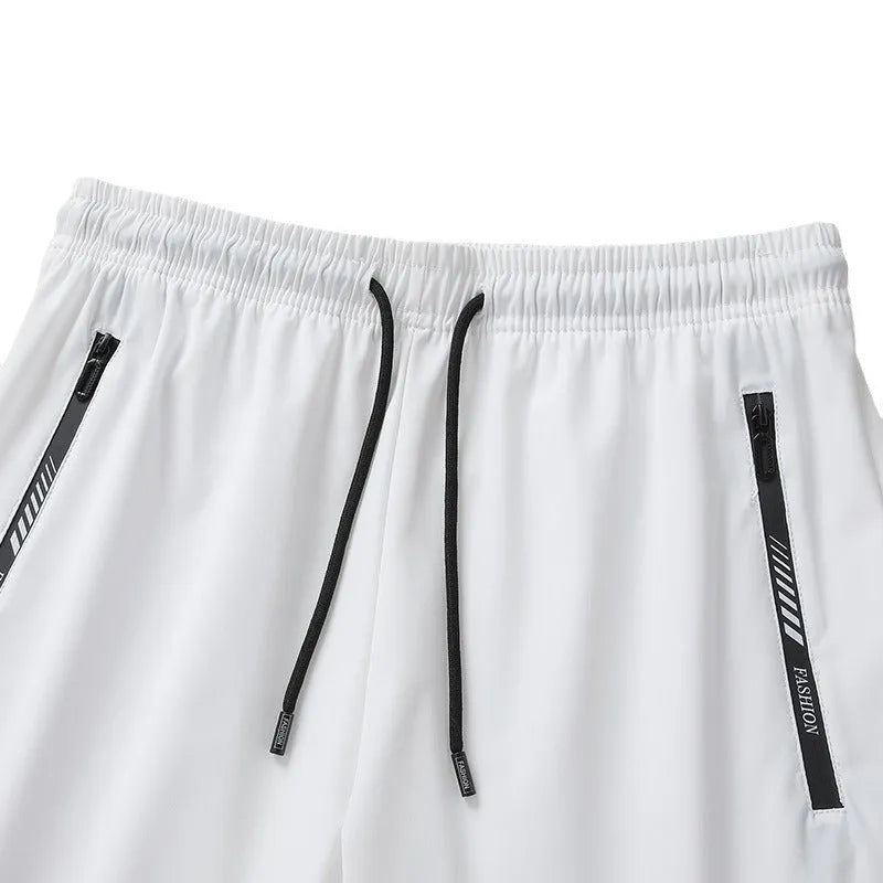Men's black quick-dry nylon sports shorts with loose fit and fifth pants length on hanger