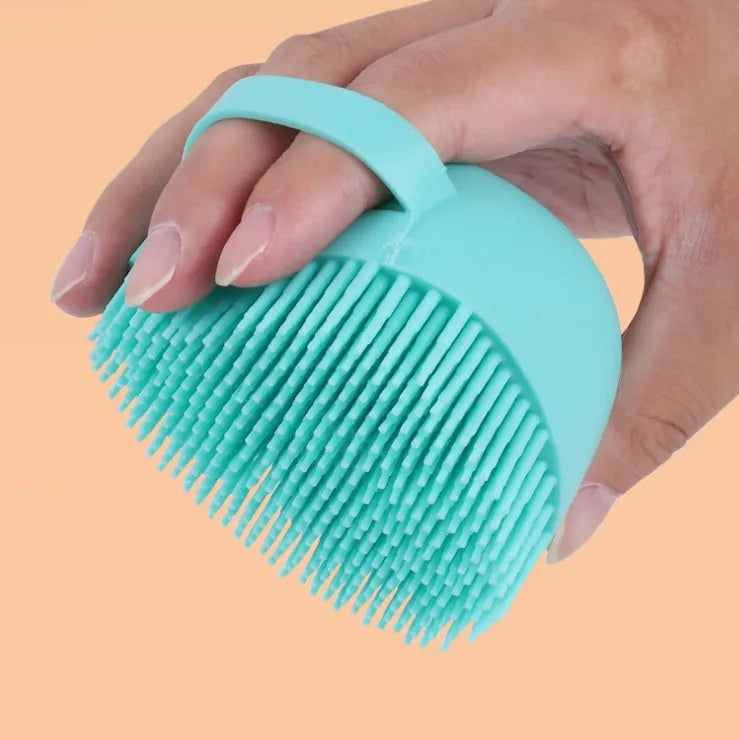 Blue silicone dog bath brush with handle for pet washing and massage during grooming