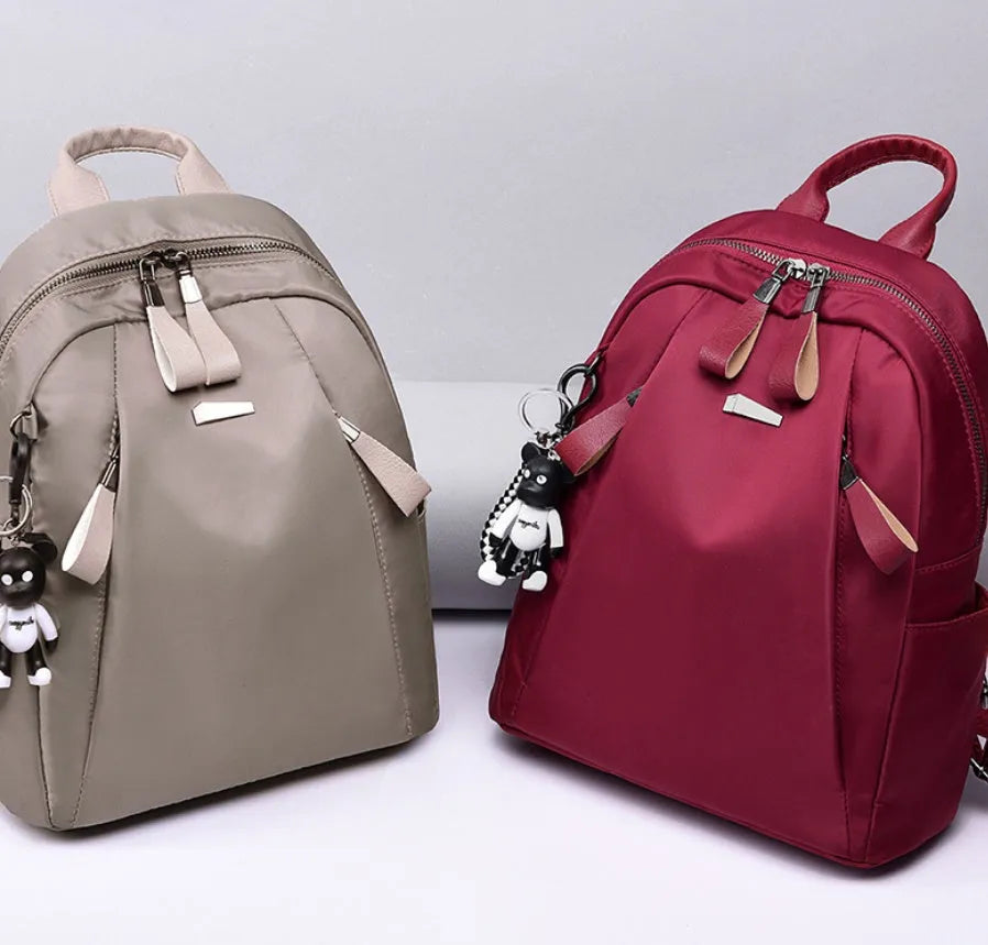 Medium wild fashion rucksack in Oxford cloth with vertical square shape, double straps, and zipper closure available in black, gray and wine red