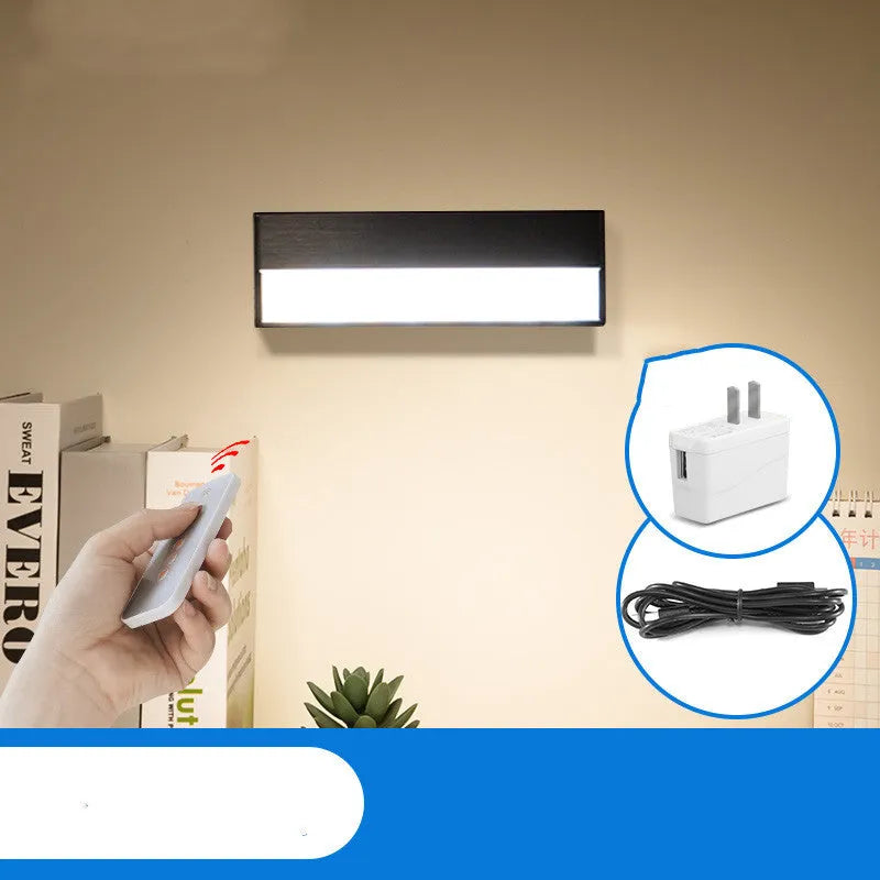White and black portable magnetic LED desk lamp with adjustable dimming on a wooden desk