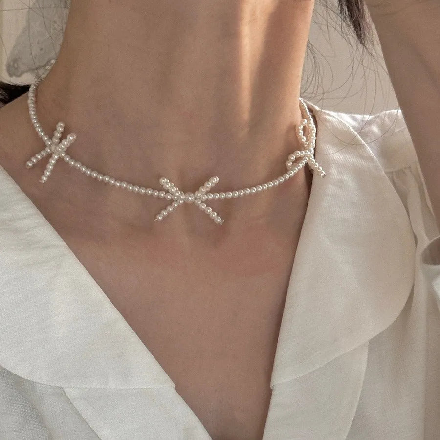 White sweet bow pearl necklace for women on an adjustable 31cm-40cm chain.