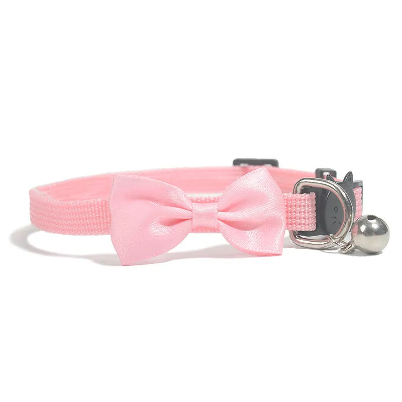 Adjustable striped nylon cat collar with a bell shown in multiple colours including red, blue, green, and pink.