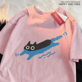 A plus-size woman's black short sleeve cotton T-shirt with a diving cat graphic, shown in a straight cut fit.