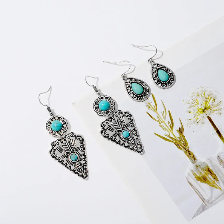 Pair of retro alloy earrings for women in triangle style with national design for travel and photo outfits.