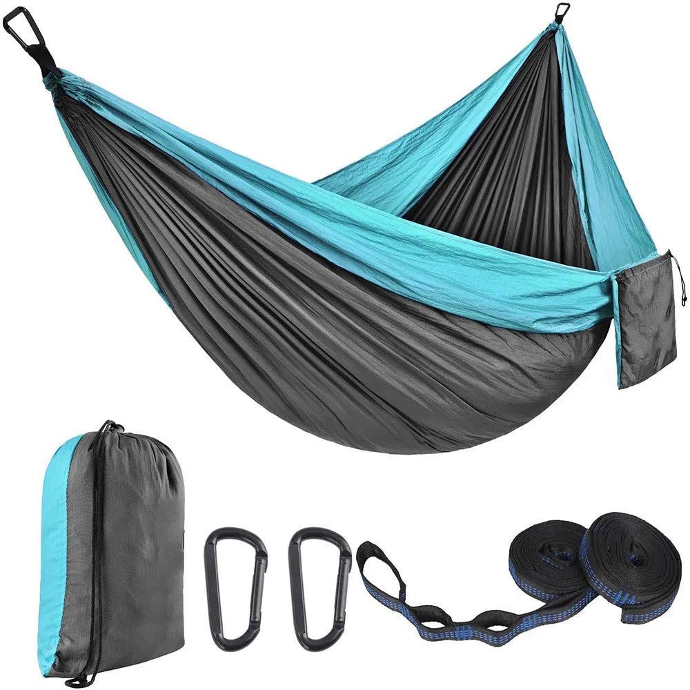 Double camping hammock with ropes and buckles shown in outdoor setting
