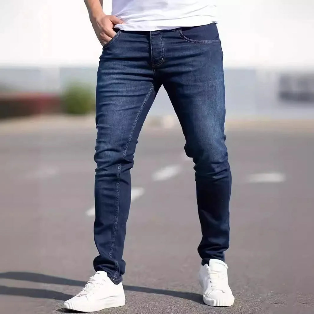 Men's dark blue slim fit casual jeans with a skinny leg and zip fly closure