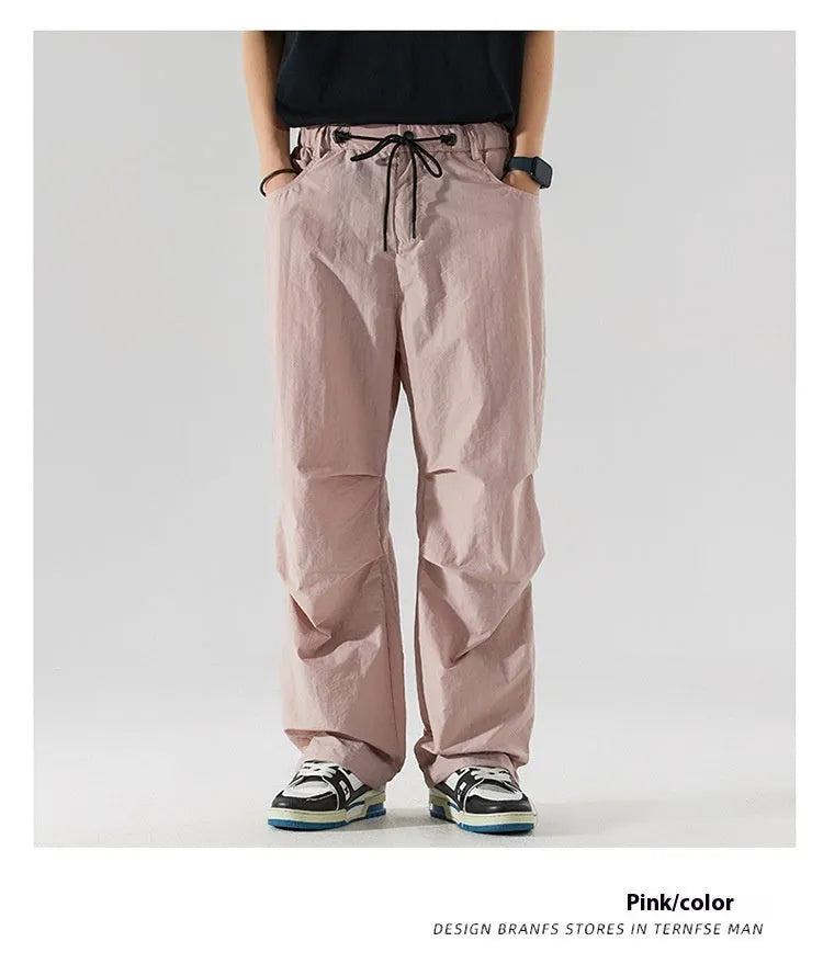 Man wearing loose straight-leg casual trousers in thin ice silk nylon fabric, showing apricot colour option.
