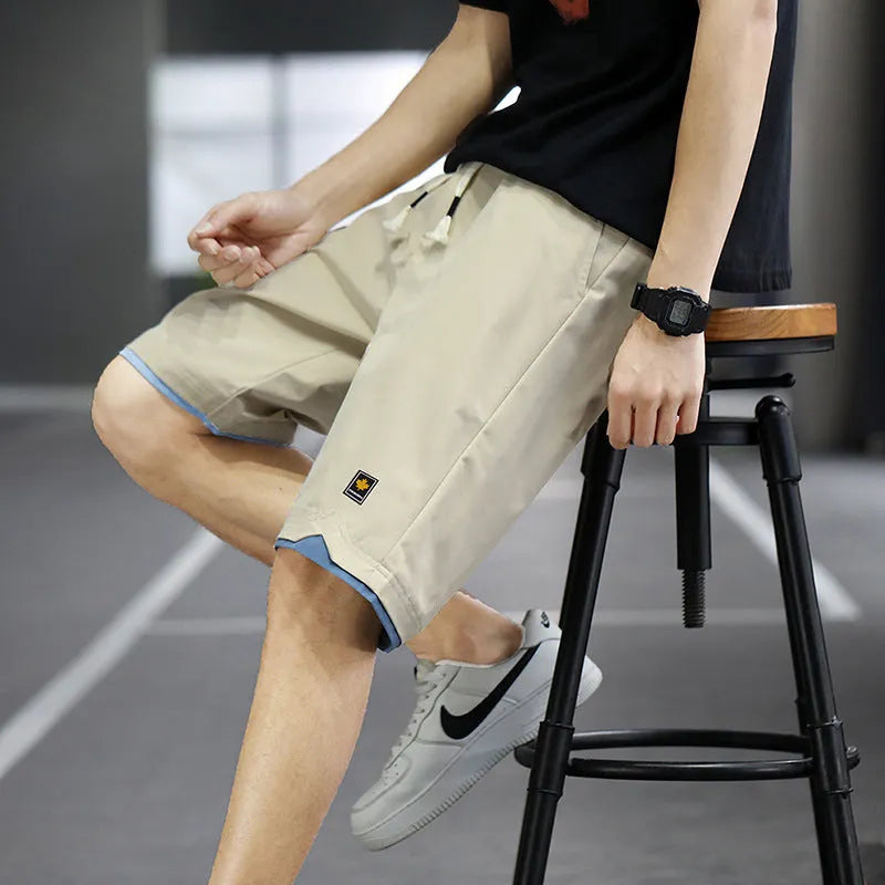 Man's loose-fitting straight-leg beach shorts in green on a neutral background.