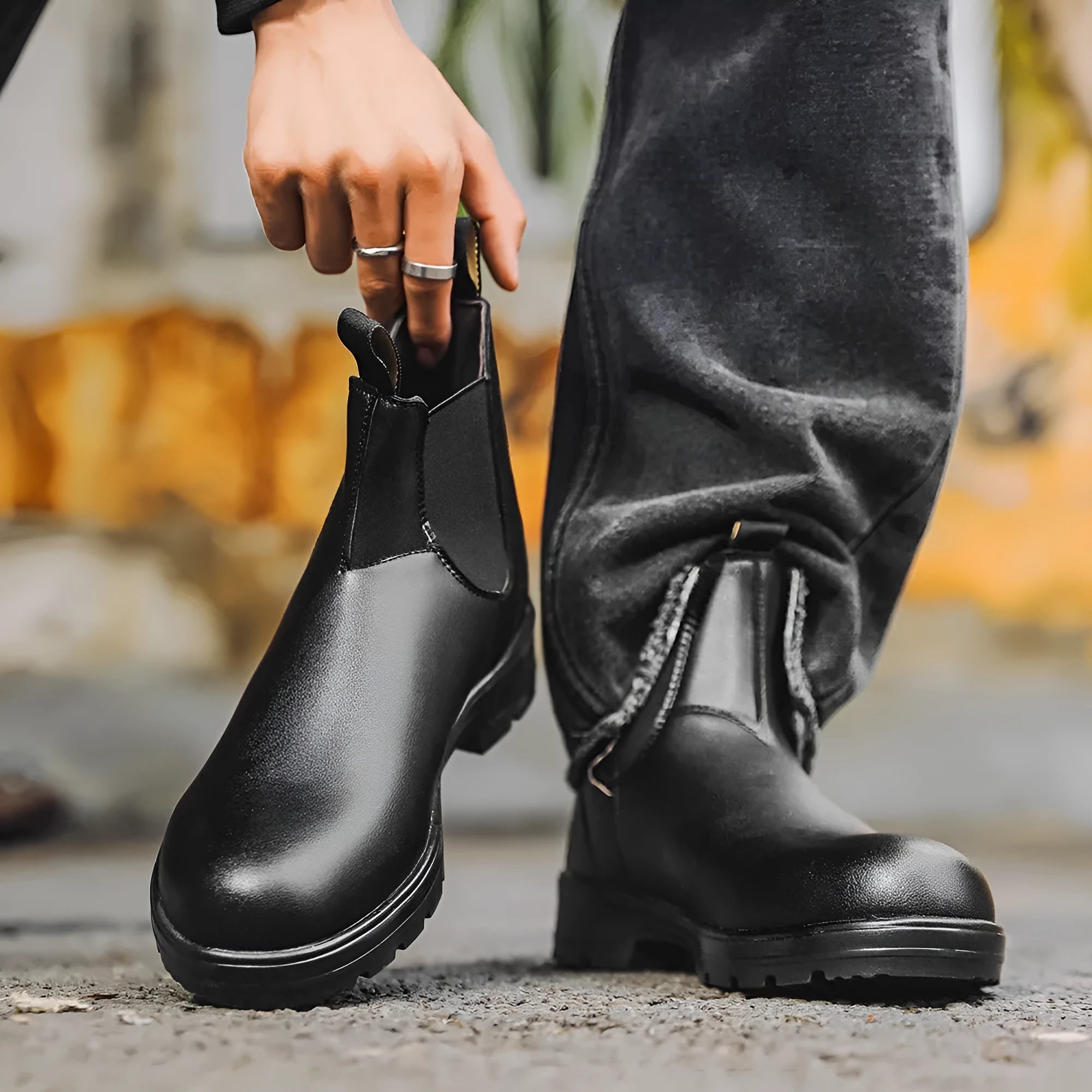 Vintage brown unisex Chelsea boots with a frosted finish, round toe, and low horseshoe heel on a wooden floor.