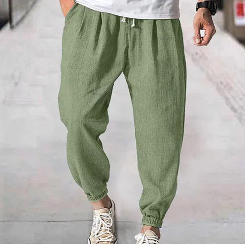 Men's casual cotton trousers with banded ankles in light green colour showing loose fit summer style
