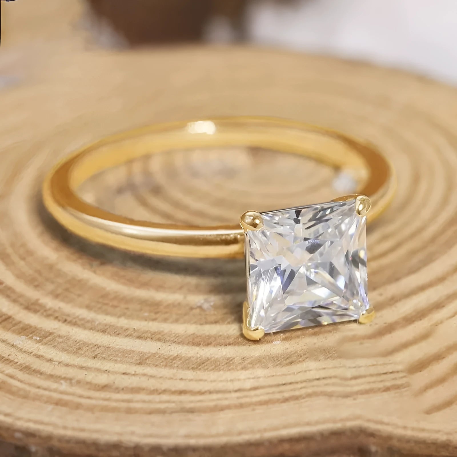 A simple geometric women's ring in polished 925 silver with a round zirconium crystal, shown in silver, gold, and rose gold colour options.