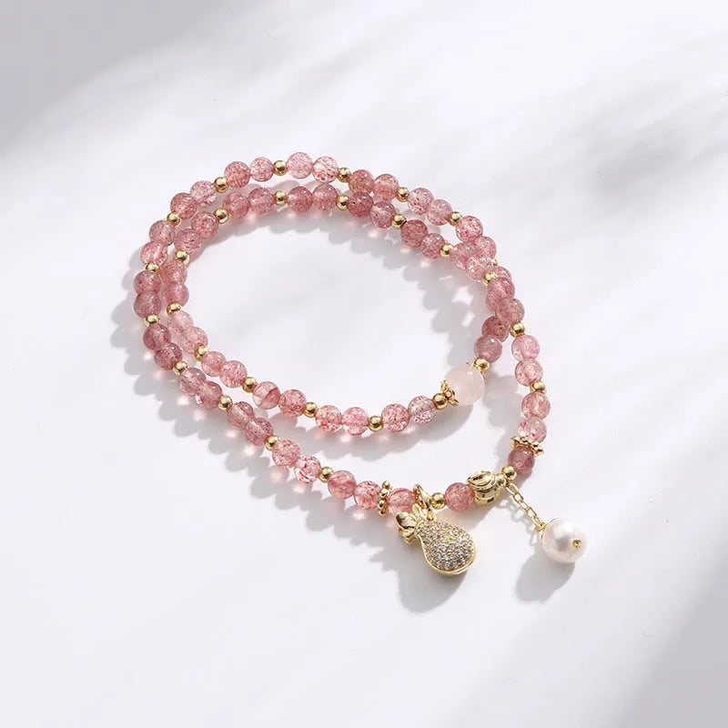Women's strawberry quartz bracelet with geometric wallet-style design and adjustable beaded construction