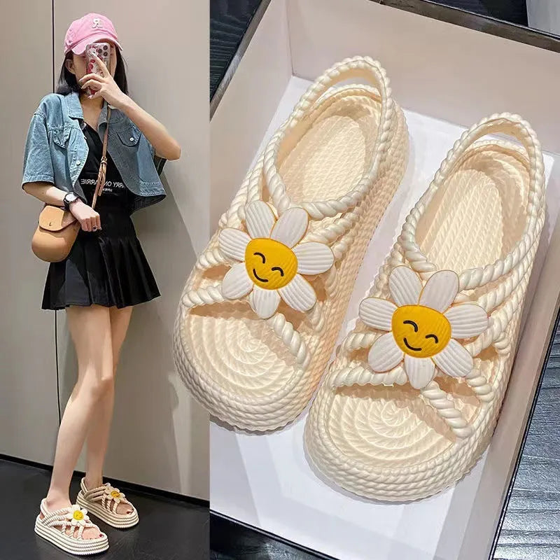 Beige PVC sandals with sunflower pattern and round toe on a non-slip sole.