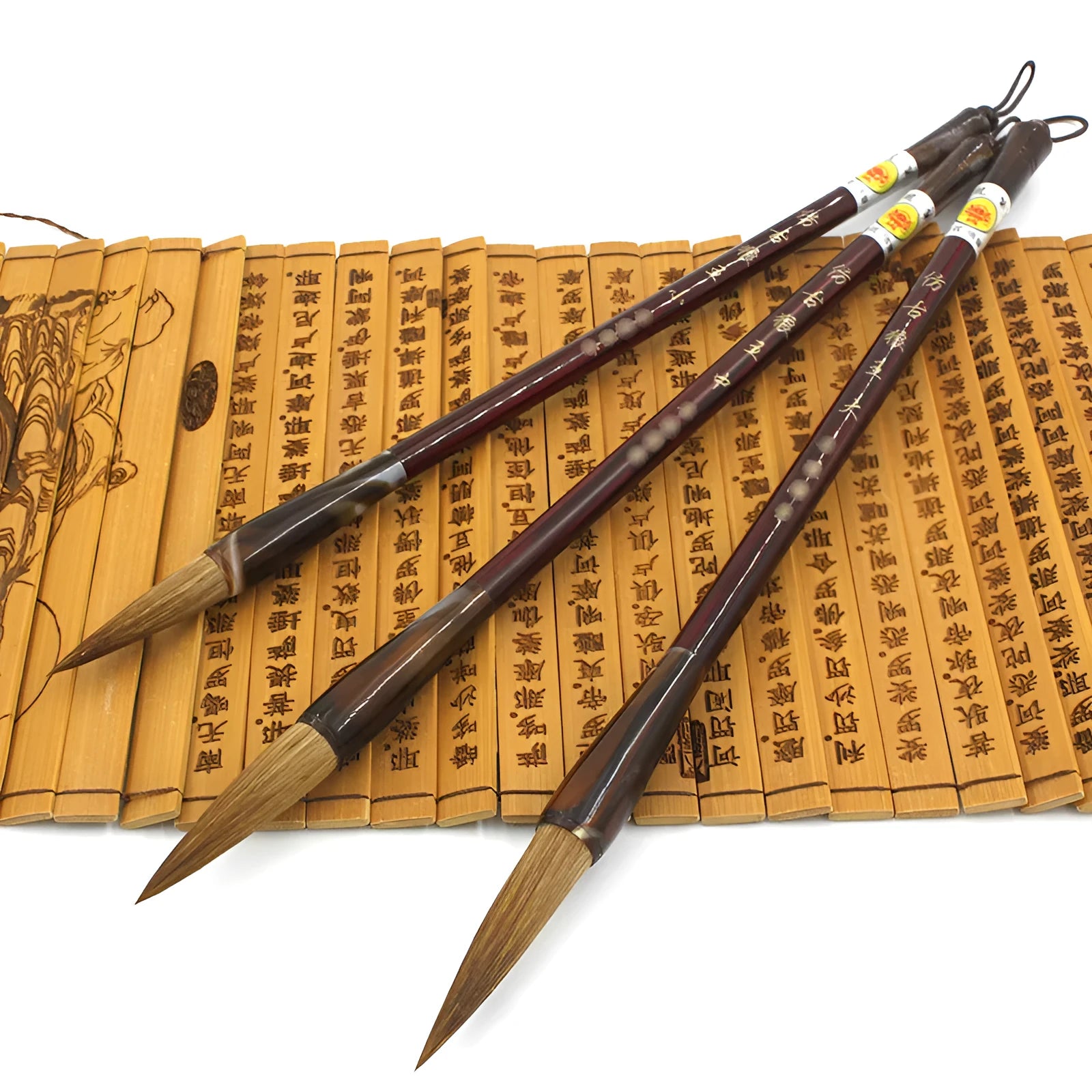 Traditional Chinese wolf hair calligraphy brush with steel rod, shown in large, medium, and small sizes.