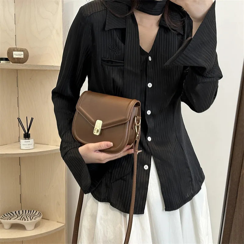 Soft PU leather horizontal square messenger bag with clamshell opening in khaki colour.