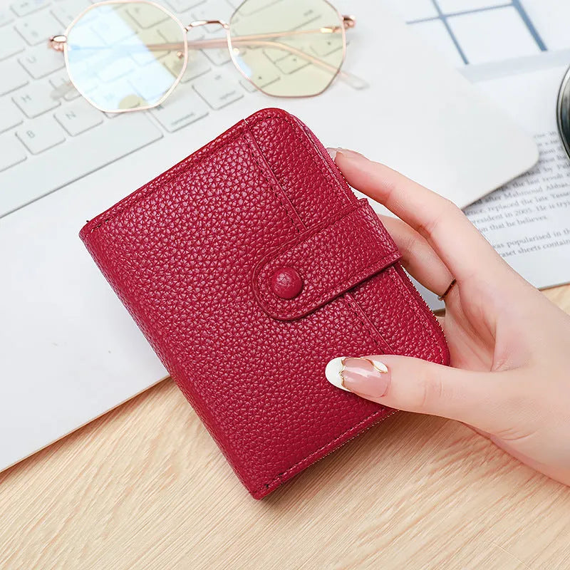 Ladies short pu leather wallet with lychee pattern in beige, showing two-fold design with card slots.