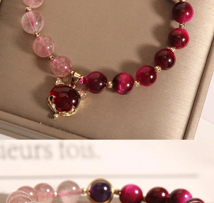 Strawberry crystal bracelet with elastic rope on wrist showing 18cm circumference