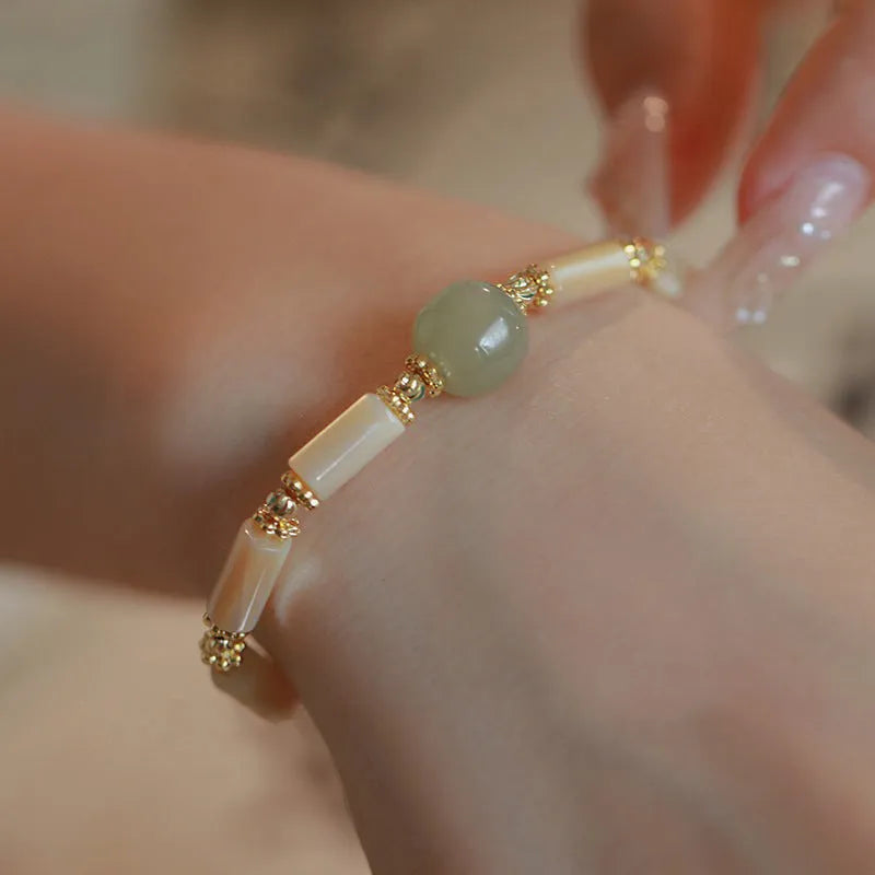 Hetian jade white lip shell bracelet with geometric round design on wrist