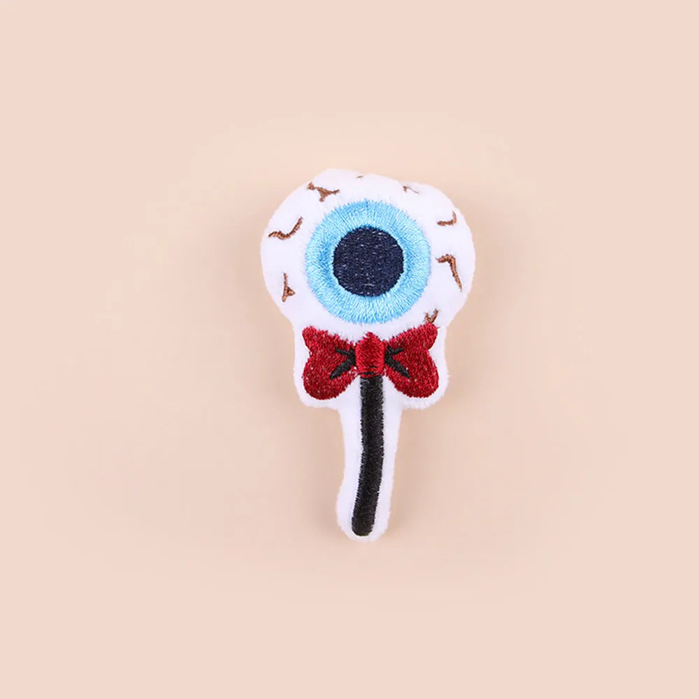 Small cat teaser wand with a soft plush head in eyes, candy, or skull design